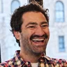 Jeremy Lyman of Birch Coffee, smiling by a café window